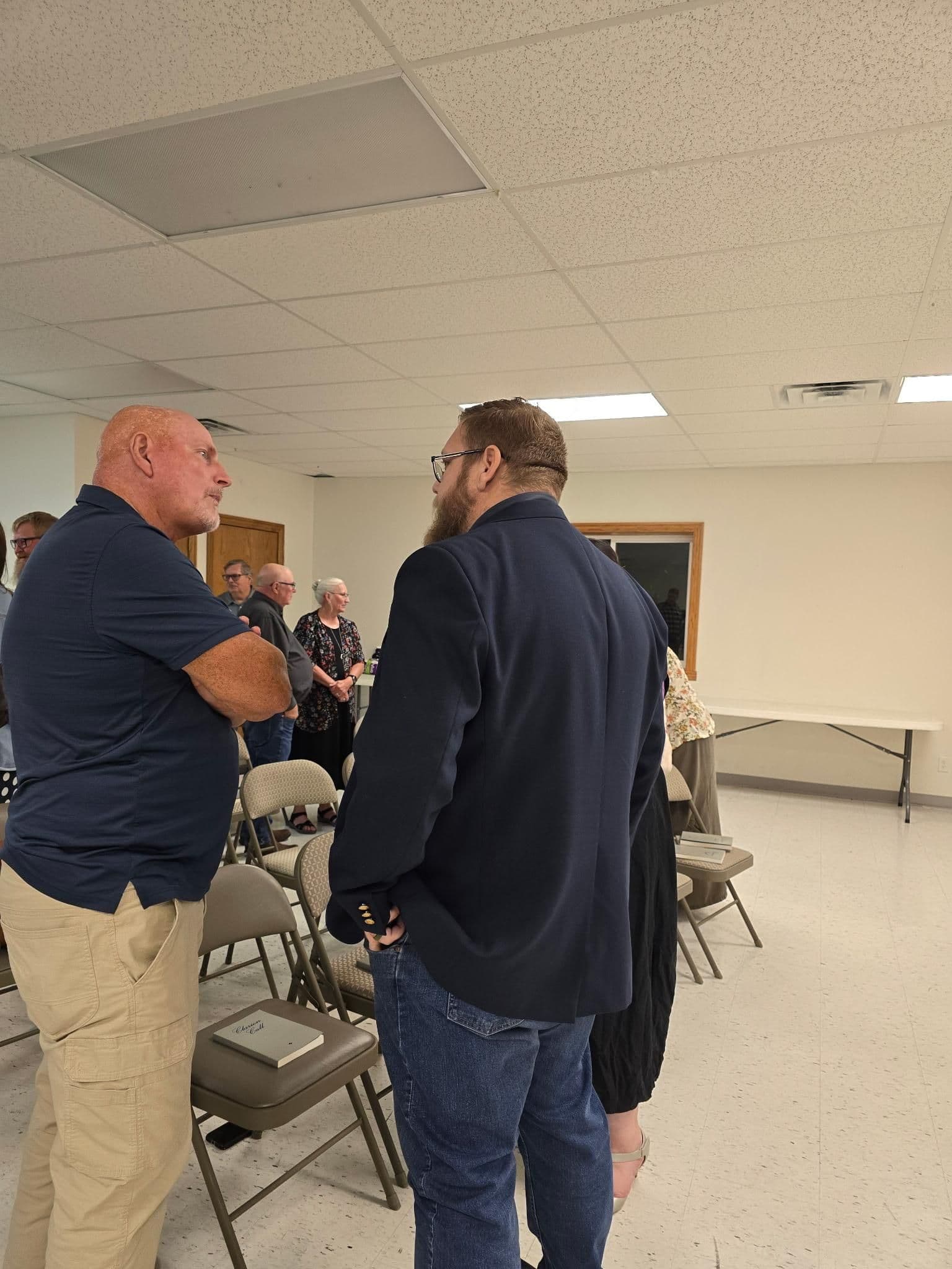 Two brothers in conversation after service